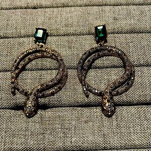 Gold and emerald snake earrings with crystals.